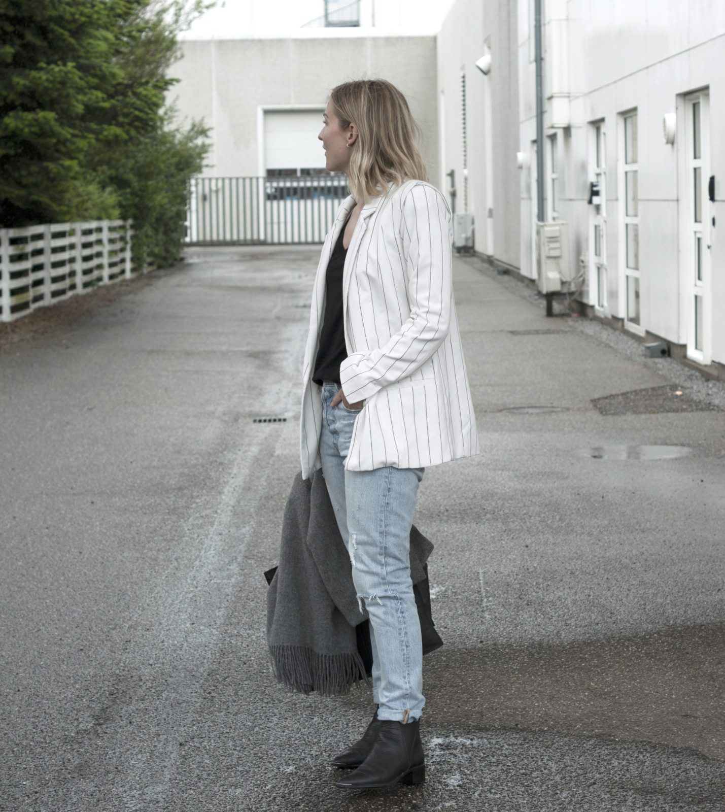 Style: pinstriped blazer and blue jeans.